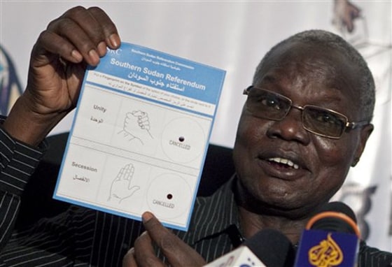 Justice Chan Reec Madut, center, the chairman of the Southern Sudan Referendum Bureau, shows the referendum ballot during a press conference in Juba, southern Sudan on Monday. 